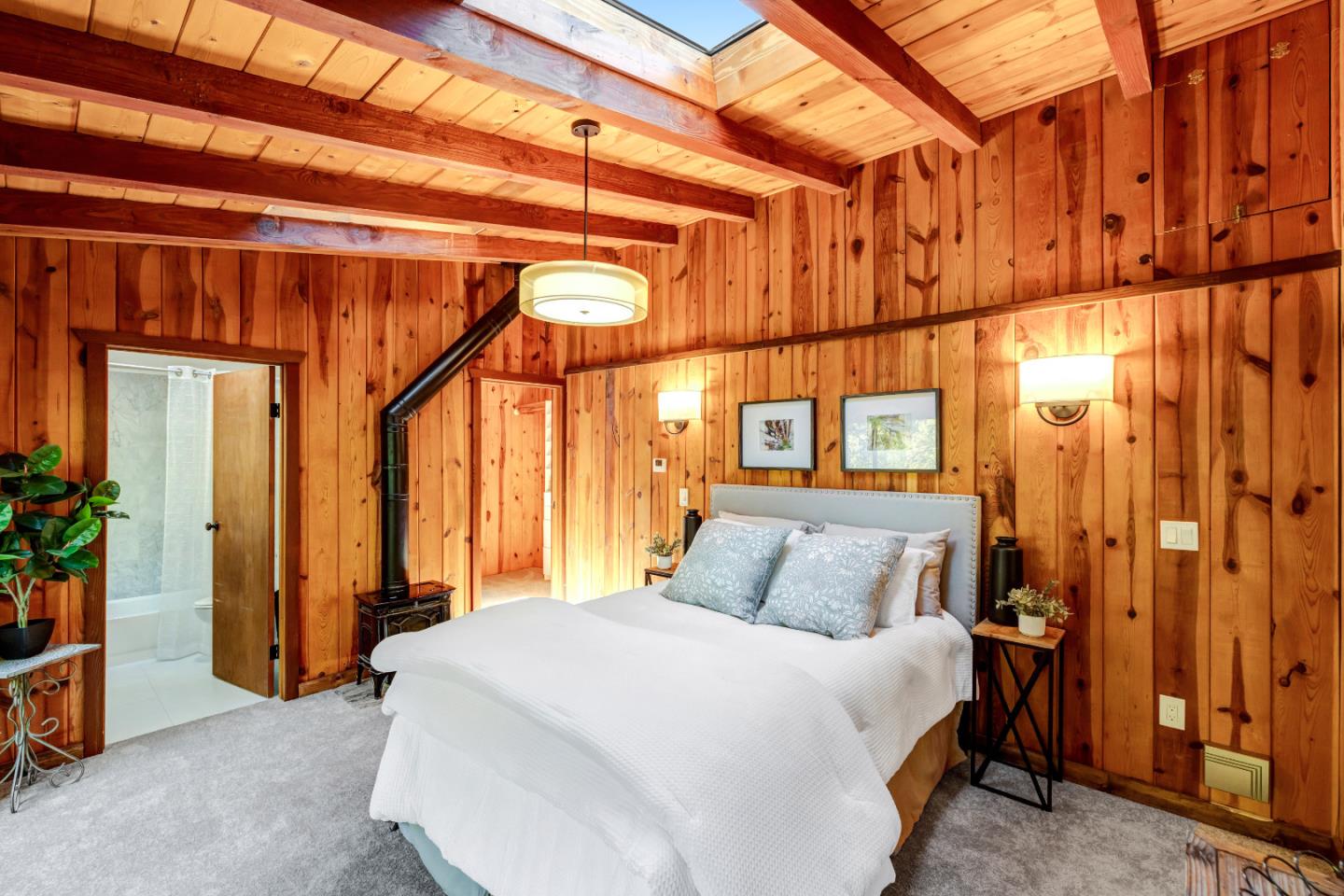 220 Lazy Woods Road Felton, CA 95018 - Photo 21 of 69 a bedroom with a bed and a chandelier