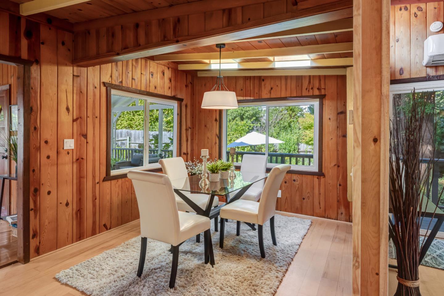 220 Lazy Woods Road Felton, CA 95018 - Photo 9 of 69 a dining room with wooden floor a glass table and chairs