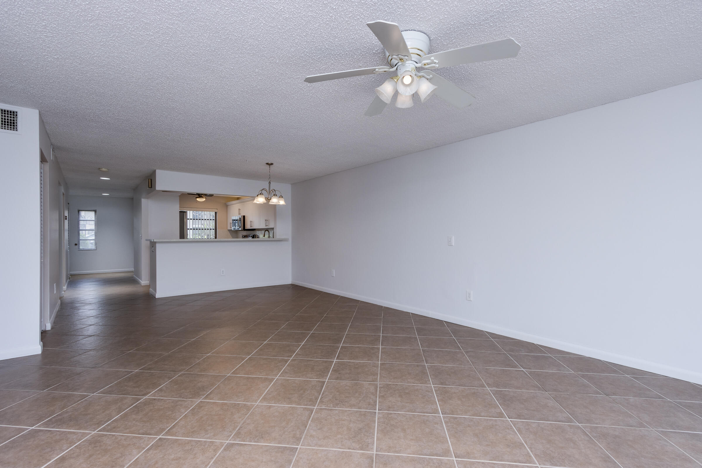 8535 Casa Del Lago, Unit 37E Boca Raton, FL 33433 - Photo 12 of 39 wooden floor in an empty room with a window