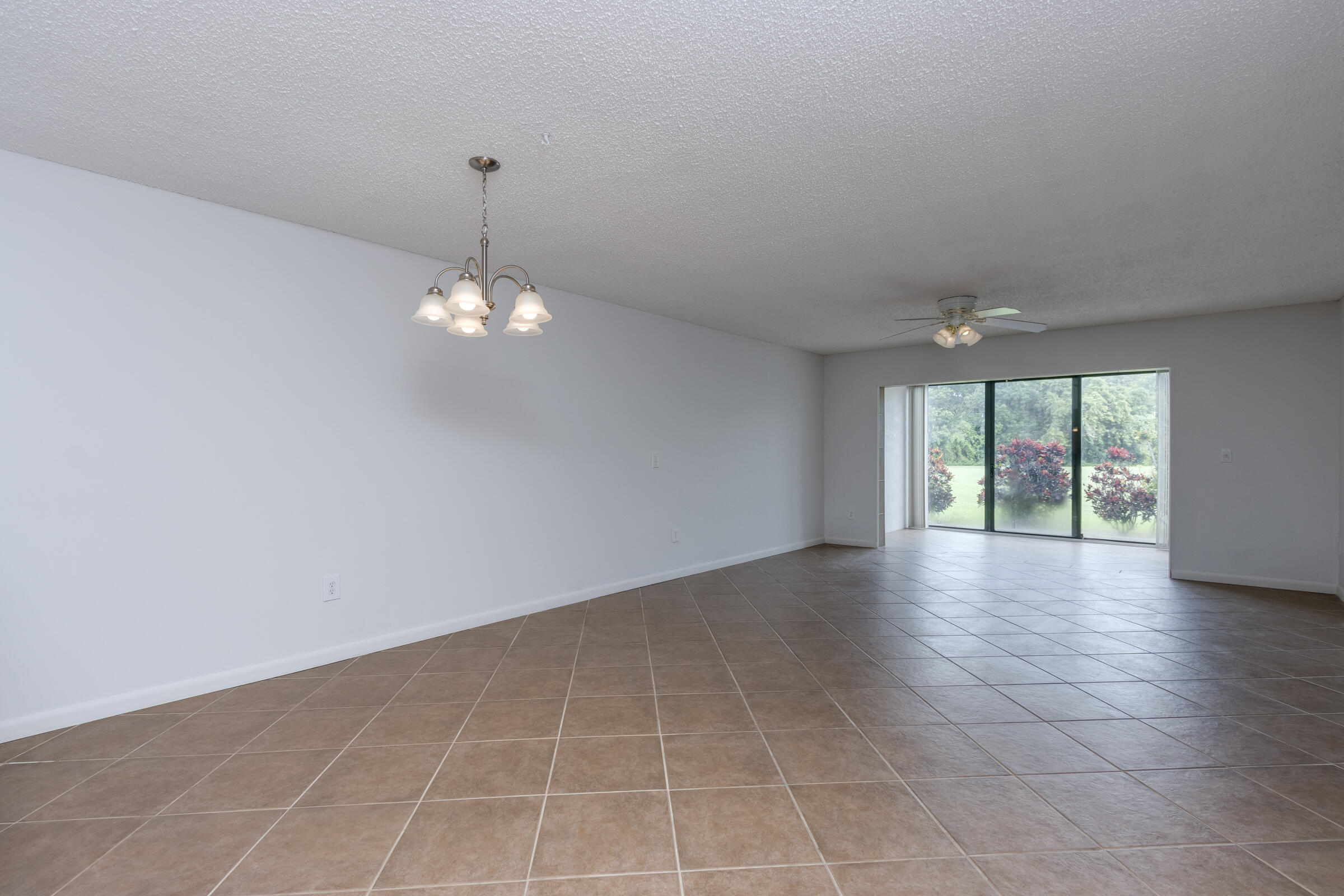 8535 Casa Del Lago, Unit 37E Boca Raton, FL 33433 - Photo 14 of 39 a view of an empty room with wooden floor and a window