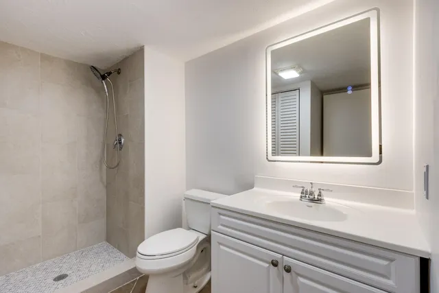 a bathroom with a sink toilet and shower