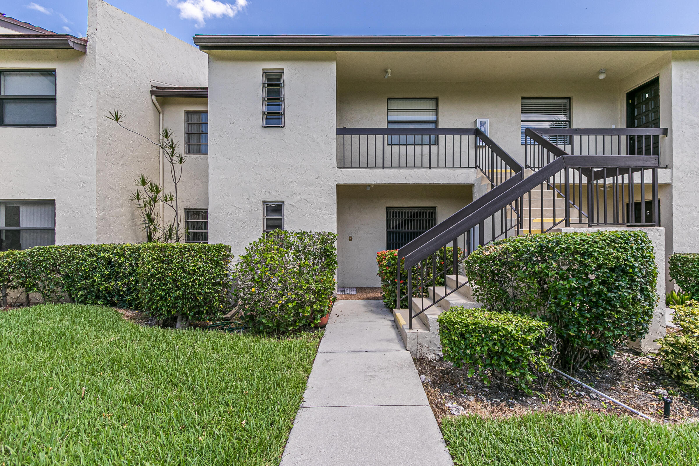 8535 Casa Del Lago, Unit 37E Boca Raton, FL 33433 - Photo 2 of 39 front view of a house with a porch