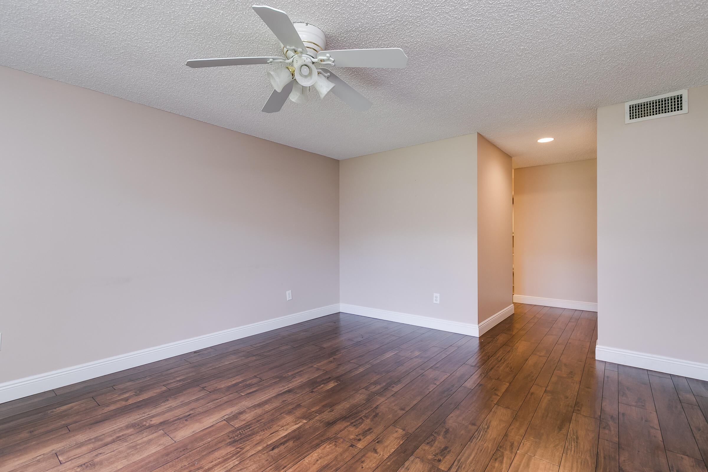 8535 Casa Del Lago, Unit 37E Boca Raton, FL 33433 - Photo 26 of 39 an empty room with wooden floor and fan
