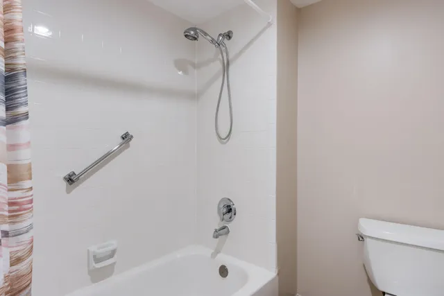 a bathroom with a shower and a toilet
