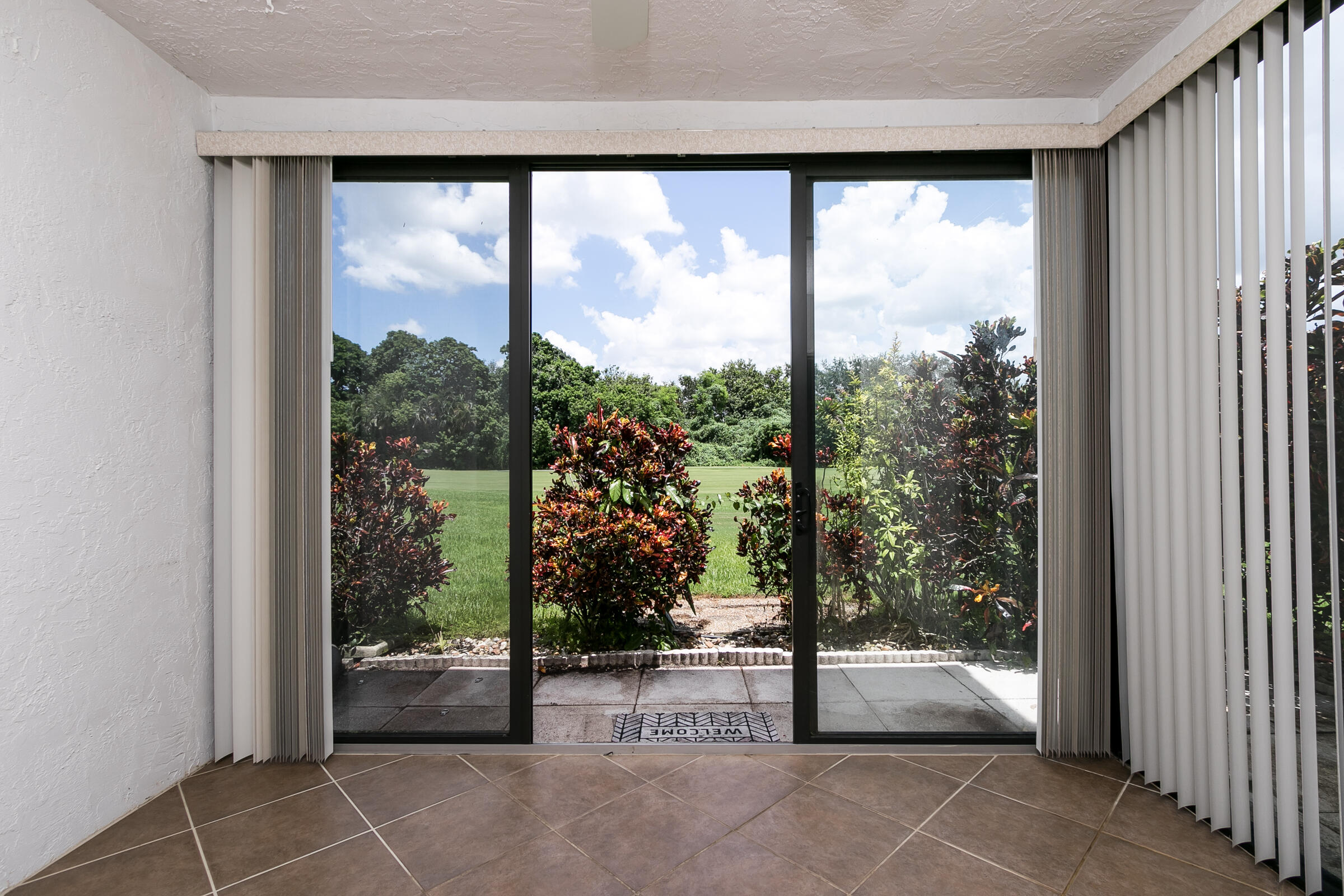 8535 Casa Del Lago, Unit 37E Boca Raton, FL 33433 - Photo 31 of 39 a view of a room with sliding glass door and mountain view