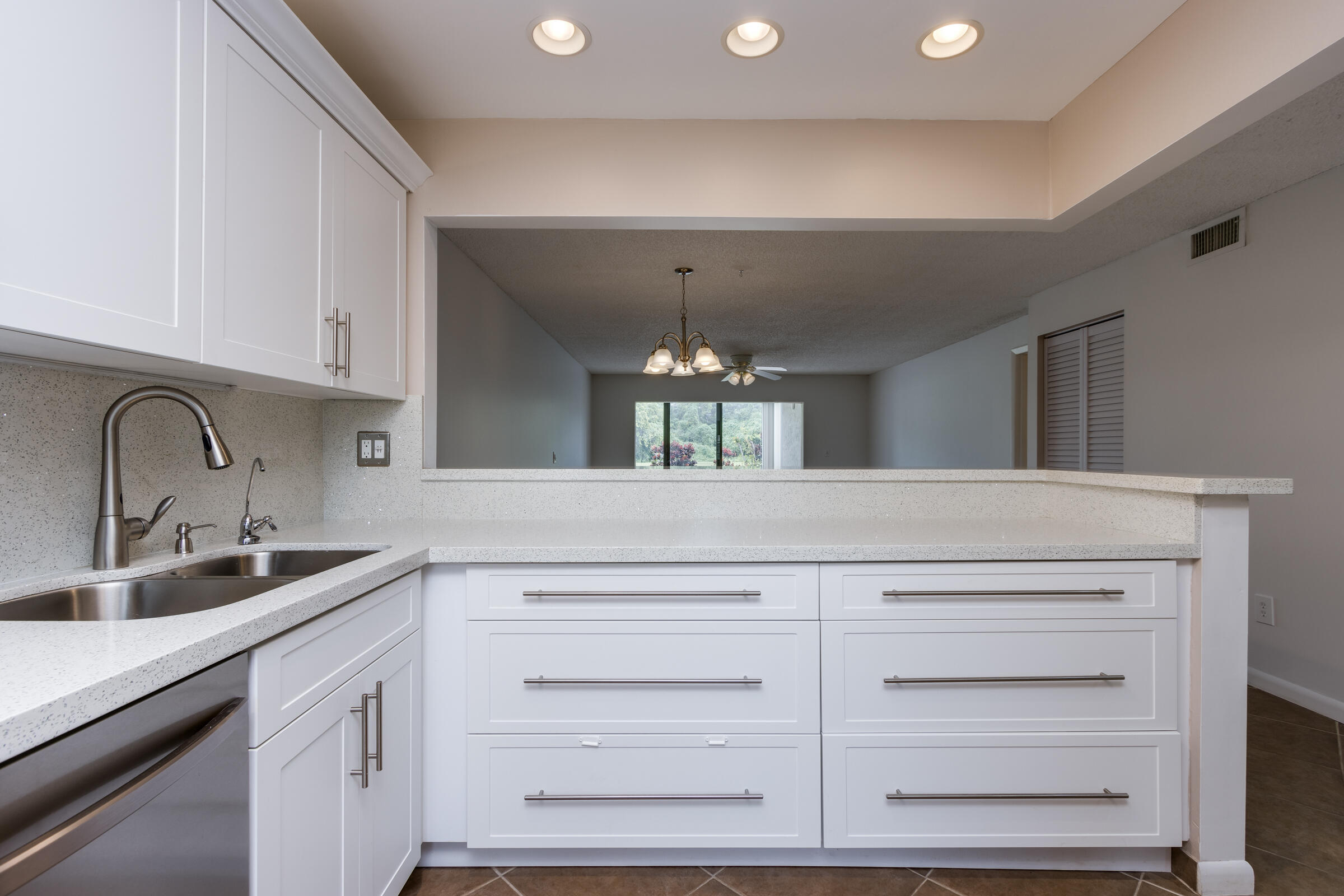 8535 Casa Del Lago, Unit 37E Boca Raton, FL 33433 - Photo 9 of 39 a kitchen with cabinets appliances and a sink