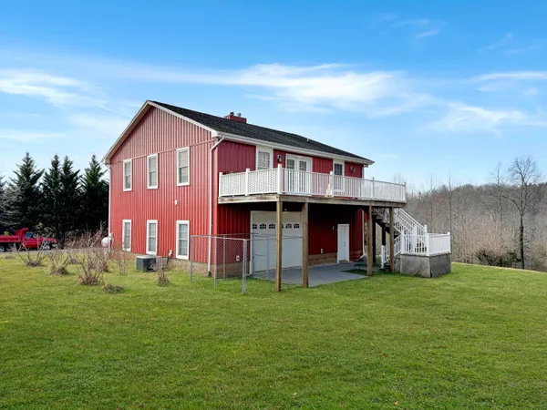 a front view of house with a garden and deck