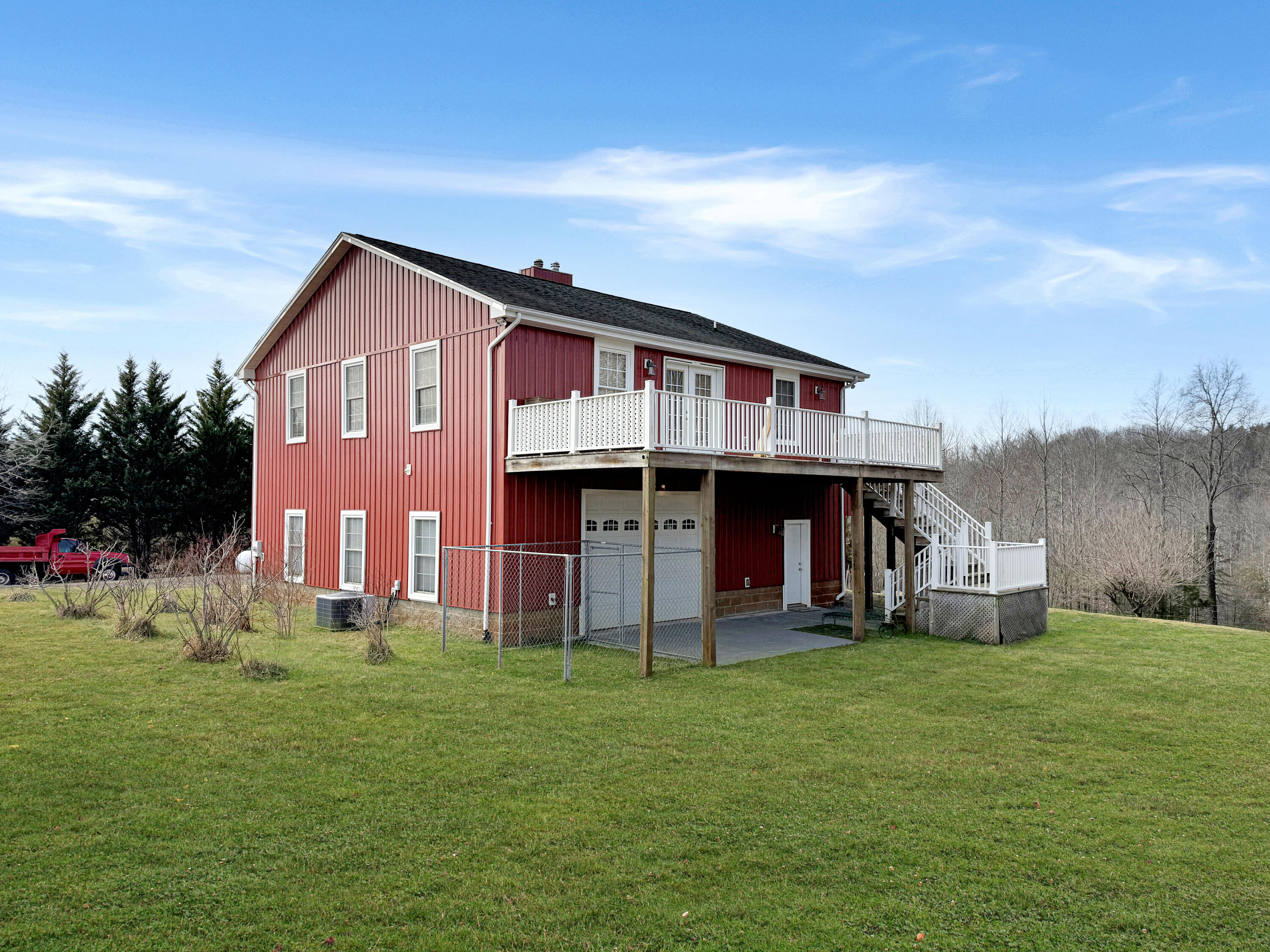 a front view of house with a garden and deck