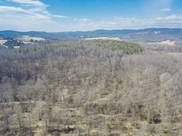 a view of mountain with sunset in background
