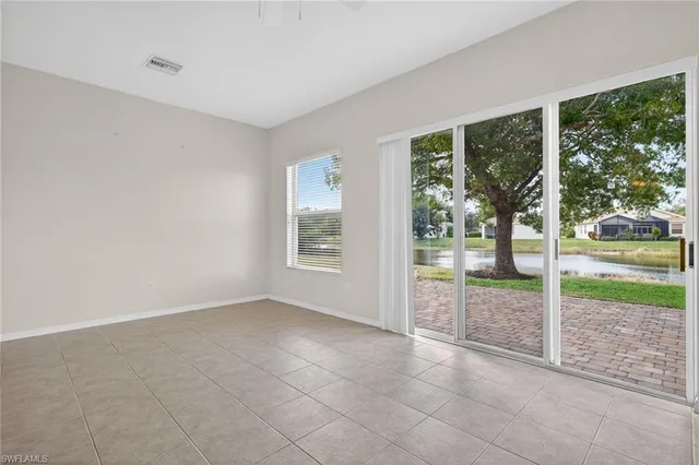 an empty room with sliding glass door and mountain view