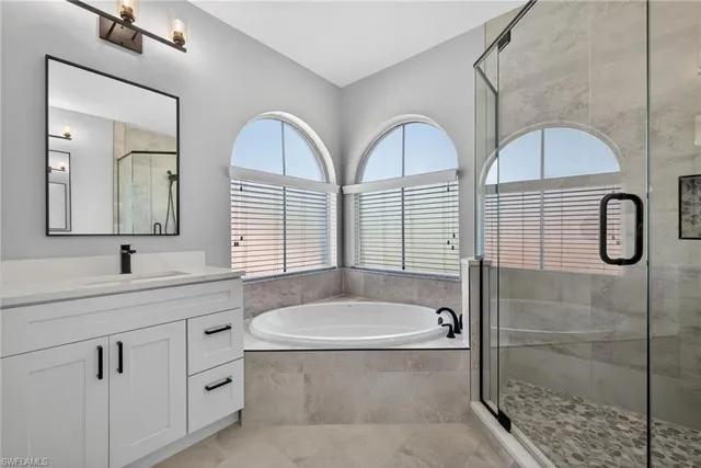 a bathroom with a shower sink and mirror