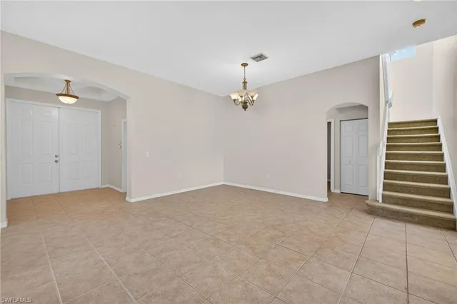 a view of an empty room with a chandelier