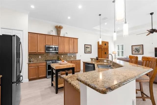 a kitchen with stainless steel appliances granite countertop a stove a microwave and cabinets