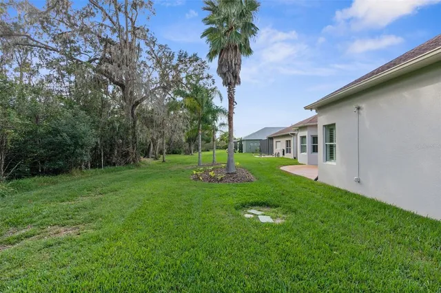 a living room with furniture a large window and wooden floor