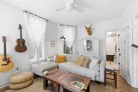 a living room with furniture and a chandelier
