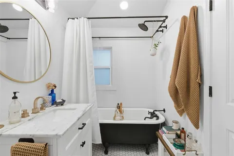 a bathroom with a sink vanity and a mirror