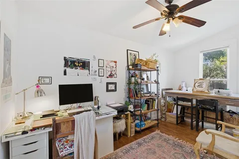 a view of a workspace with furniture and a flat screen tv