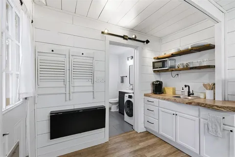 a kitchen with cabinets and wooden floor