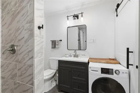 a bathroom with a sink a toilet and mirror