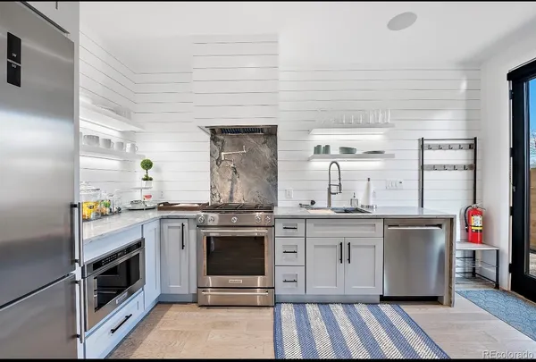 a stove top oven sitting inside of a kitchen