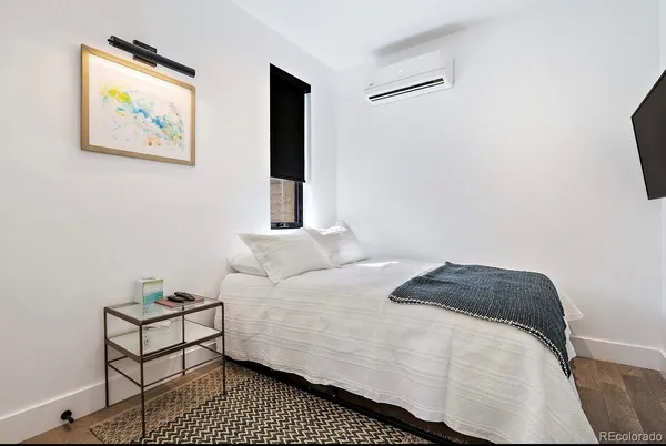 a bedroom with a bed and a chair
