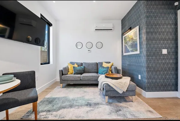 a living room with furniture and a rug