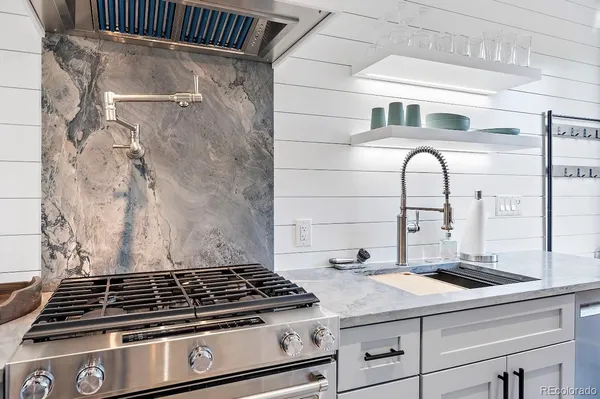 a kitchen with a sink and a stove top oven