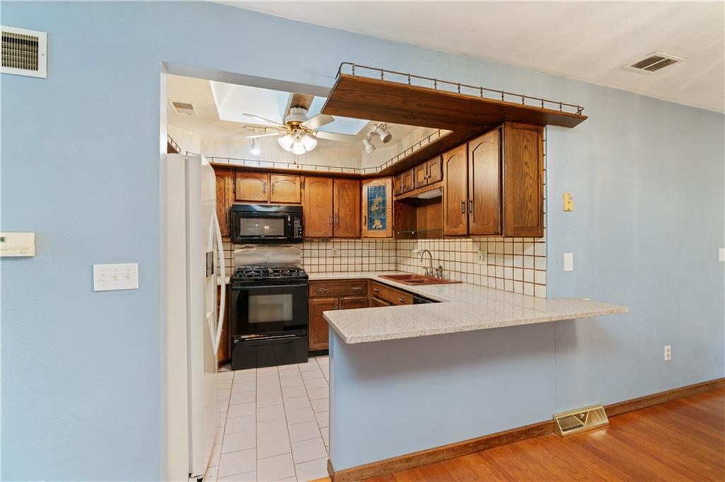1302 Rankin Road McKeesport, PA 15131 - Photo 9 of 38 a kitchen with stainless steel appliances granite countertop a stove and a sink