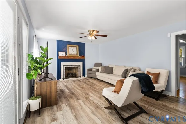 a living room with furniture a fireplace and a flat screen tv