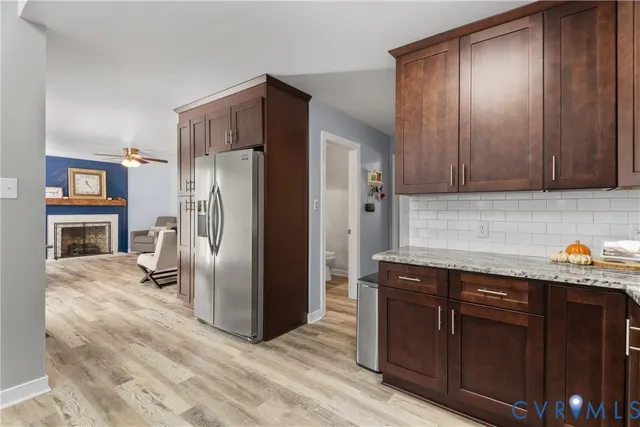 a dining room with furniture a chandelier and wooden floor