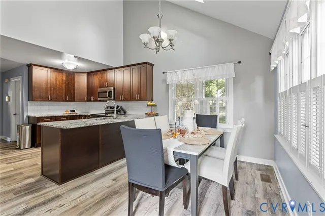 a view of a dining room with furniture and wooden floor