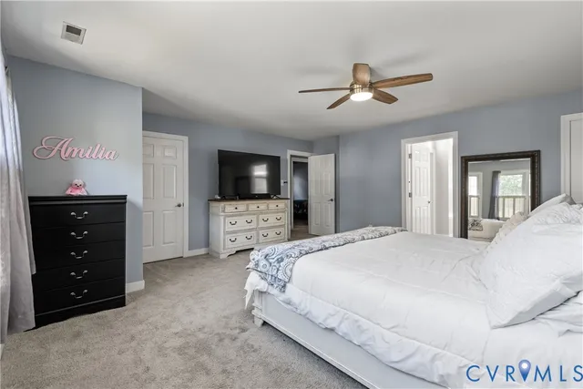 a bedroom with a large bed and a large window