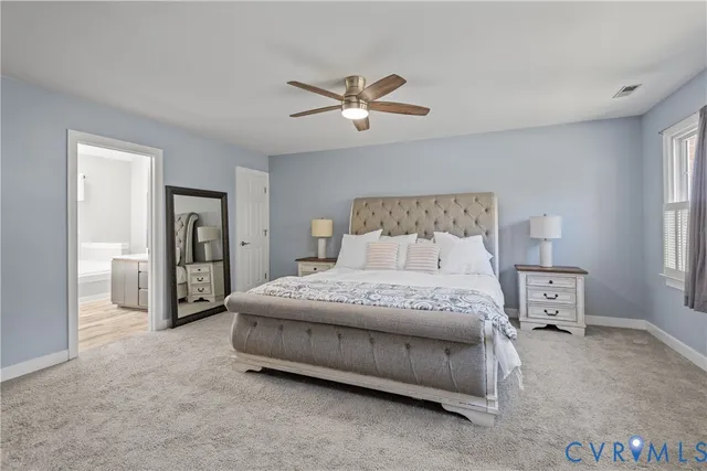 a spacious bedroom with a bed and a flat screen tv