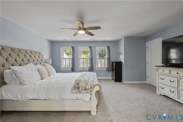 a bedroom with a flat screen television and a bed