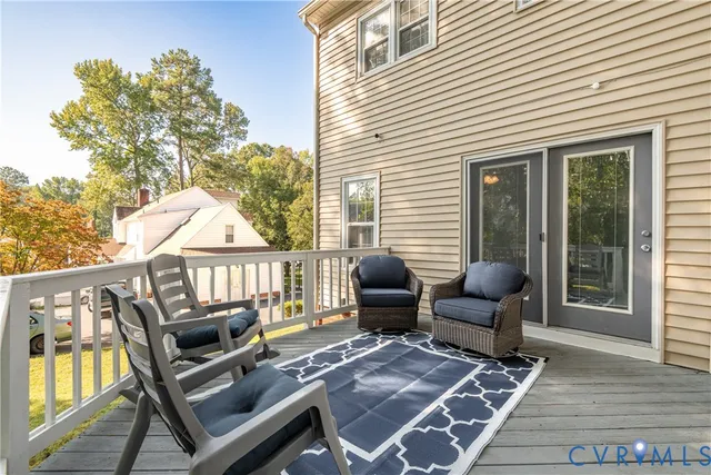 a balcony with furniture and wooden floor
