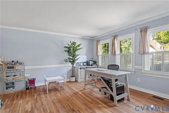 a workspace with furniture window and wooden floor