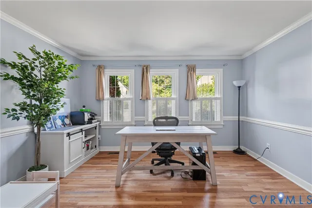 a workspace with wooden floor and window