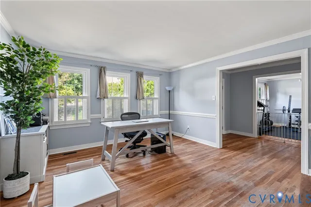 a workspace with wooden floor and a window