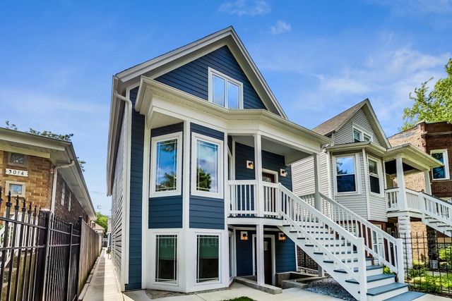 a front view of a house with iron stairs