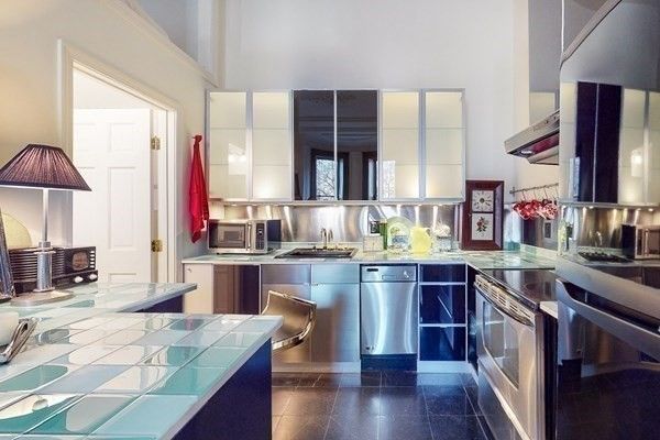 a kitchen with stainless steel appliances granite countertop a stove and a wooden floors