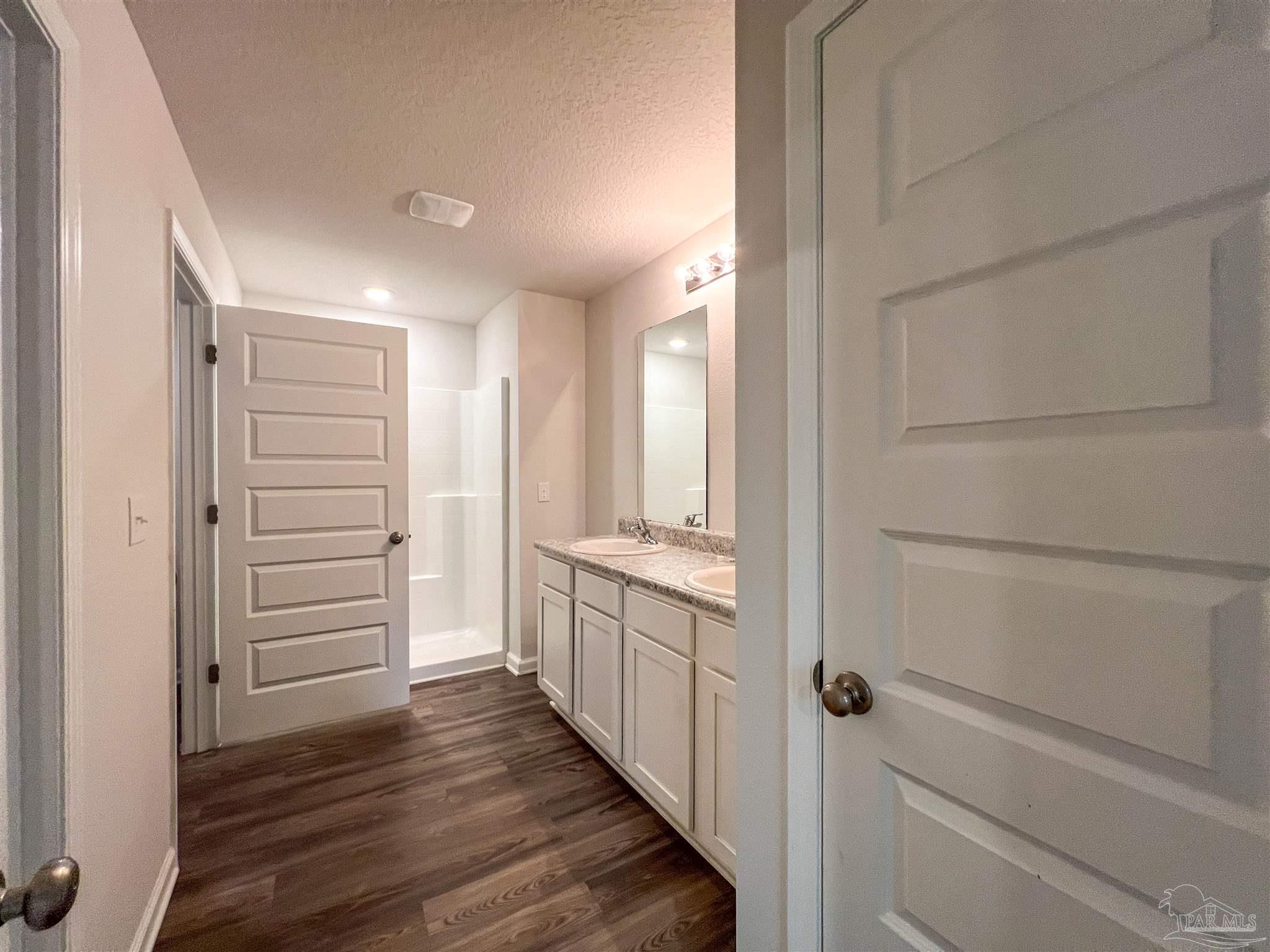 5257 Peach Drive Pace, FL 32571 - Photo 11 of 28 a bathroom with a vanity and a shower