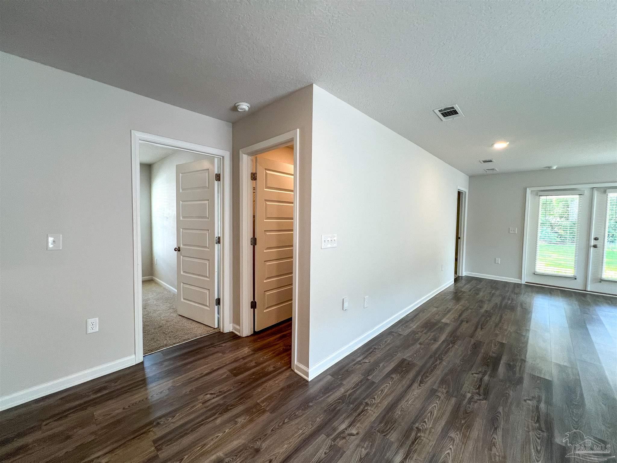 5257 Peach Drive Pace, FL 32571 - Photo 16 of 28 wooden floor in an empty room with a window