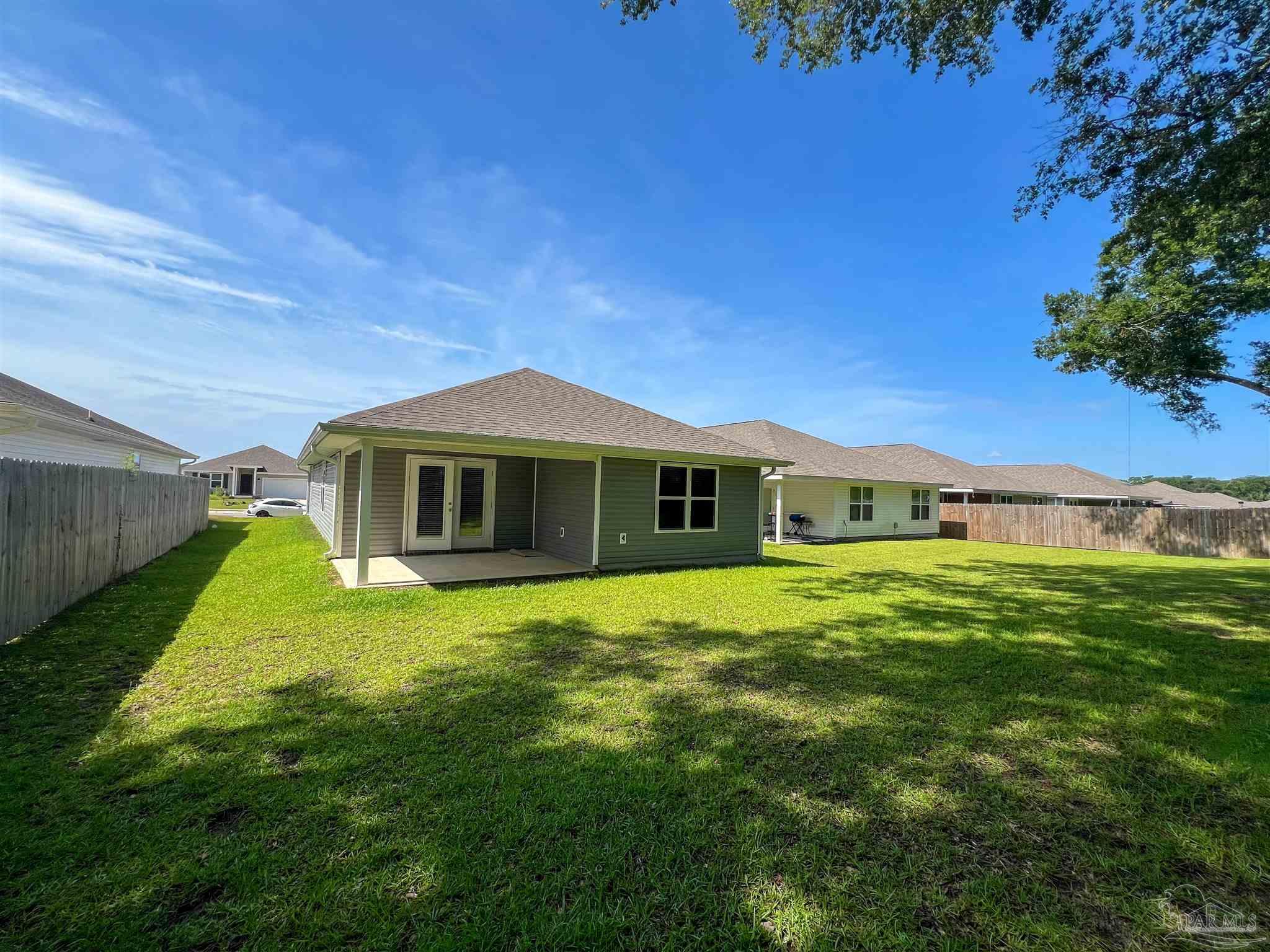 5257 Peach Drive Pace, FL 32571 - Photo 28 of 28 a yellow house with a big yard