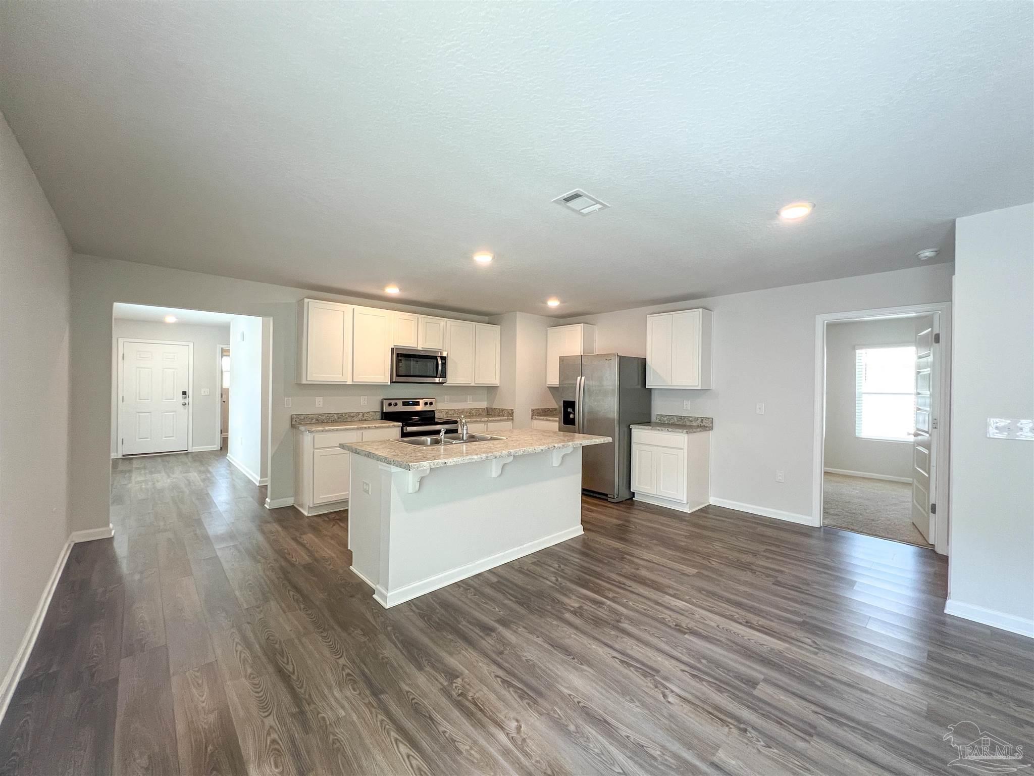 5257 Peach Drive Pace, FL 32571 - Photo 3 of 28 a view of kitchen with wooden floor and electronic appliances