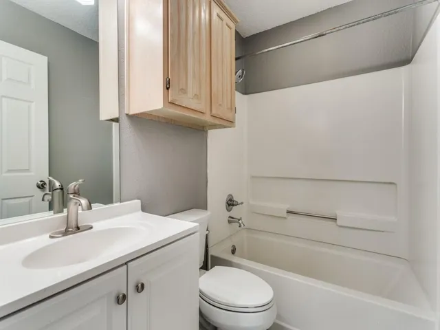 a bathroom with a sink a toilet and vanity