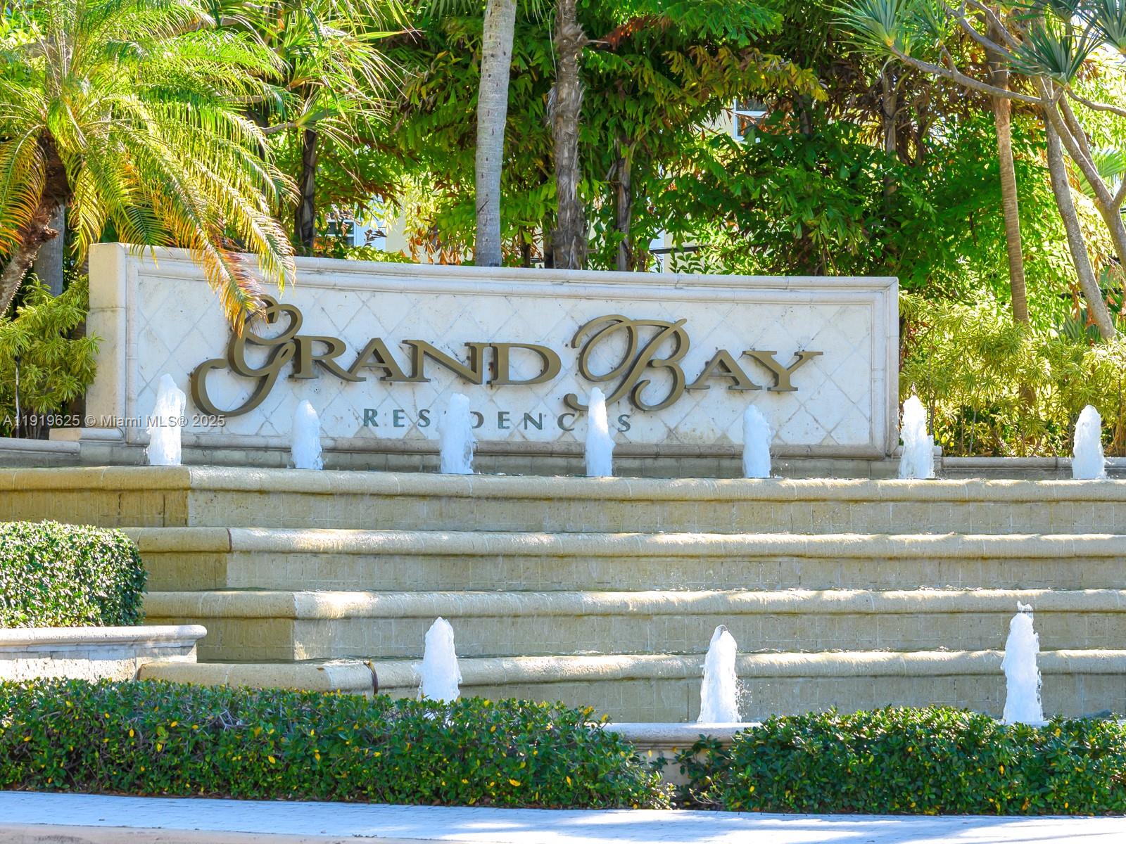 445 Grand Bay Drive, Unit 303 Key Biscayne, FL 33149 - Photo 2 of 52 a view of entrance gate and trees