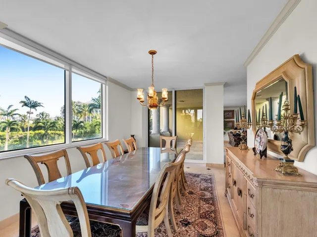 a large white kitchen with a sink and dishwasher a stove with wooden floor