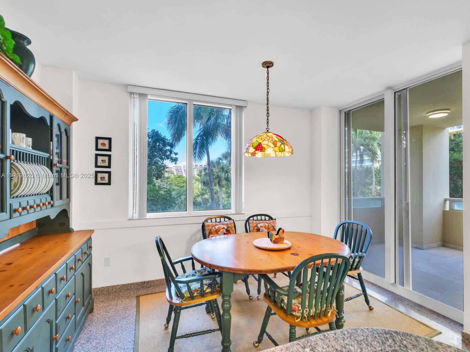 445 Grand Bay Drive, Unit 303 Key Biscayne, FL 33149 - Photo 26 of 52 a dining room with furniture and window