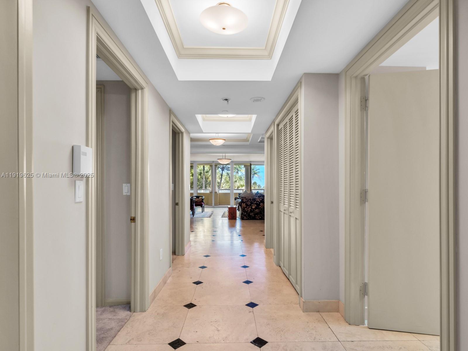 445 Grand Bay Drive, Unit 303 Key Biscayne, FL 33149 - Photo 29 of 52 a view of a hallway with dining room and furniture