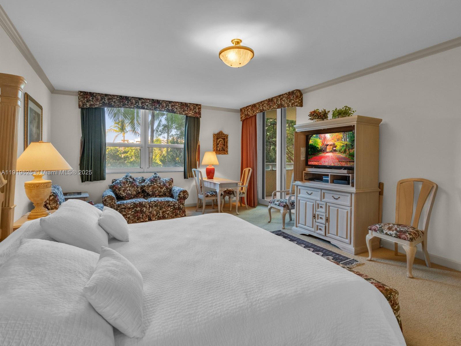 445 Grand Bay Drive, Unit 303 Key Biscayne, FL 33149 - Photo 32 of 52 a bedroom with a bed and a flat screen tv